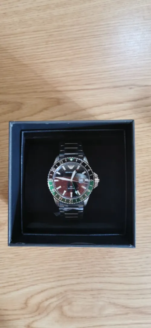Emporio Armani World Explorer watch (AR11589) features a distinctive green and black "Sprite" GMT bezel