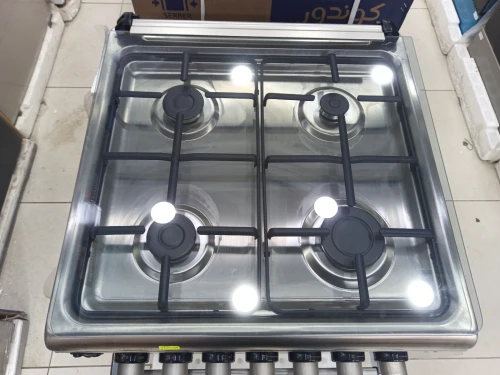 Promo cuisinière Schneider Gaz-électrique 4 feux ventilé inox fonte